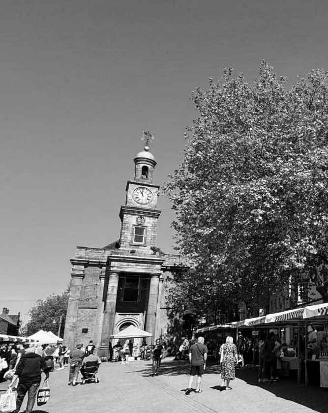 Professional web design services for businesses in Newcastle-under-Lyme, Staffordshire, featuring the town's historic market square and clock tower