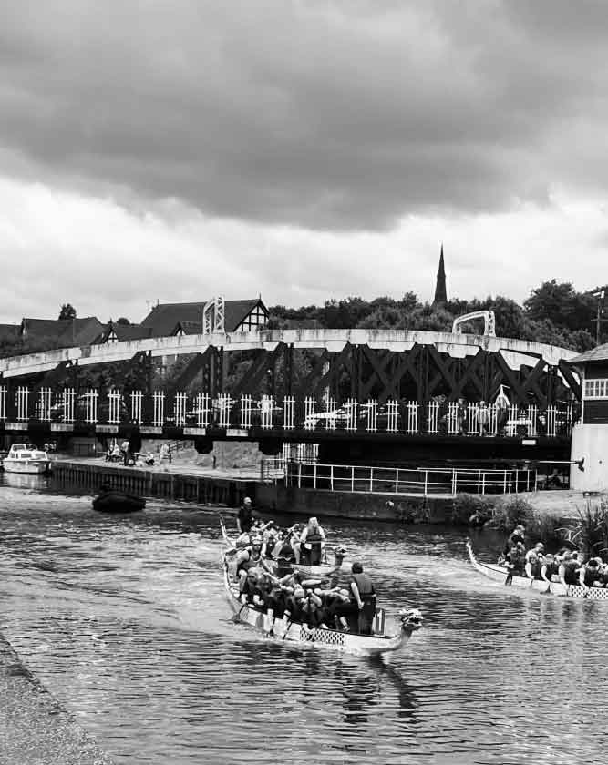 Professional web design services for businesses in Northwich, Cheshire, featuring the iconic swing bridge over the River Weaver with dragon boats